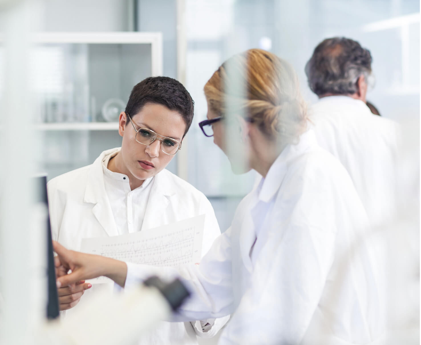 Header image of facility workers in Scorpion's analytical methods development laboratory for biologics manufacturing