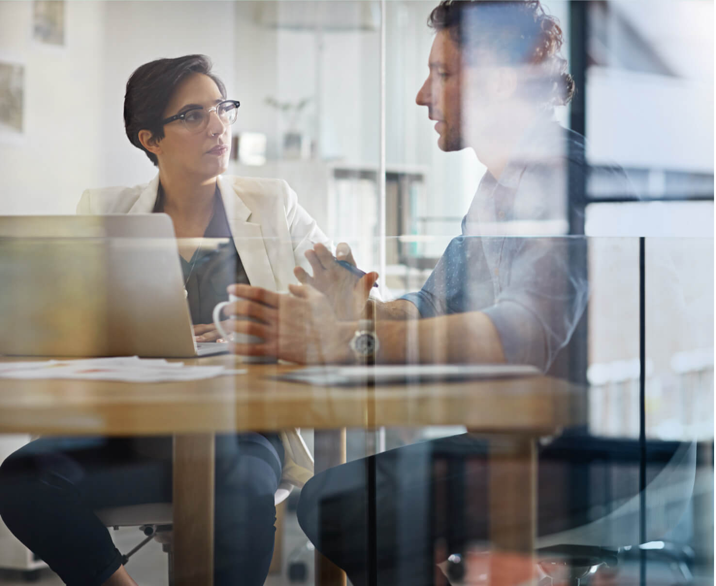 Photo showing two people discussing regulatory challenges and complexities when manufacturing and working with the manufacturing of biologics and large molecules